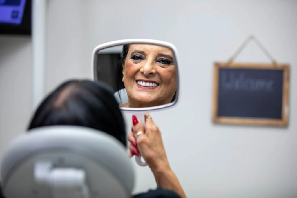 a woman smiling in a mirror
